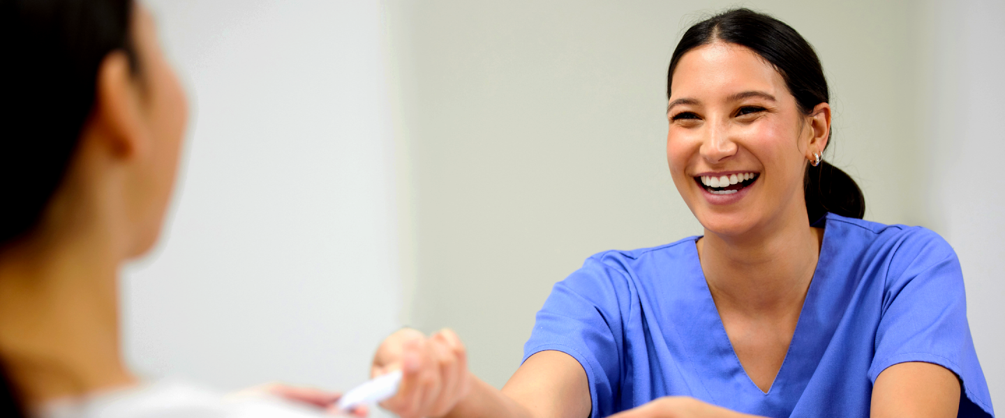 Dr. Hanrahan showing information to a patient on an ipad.